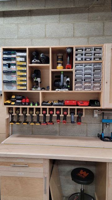 A Workbench With Lots Of Drawers And Tools On The Shelves Above It In