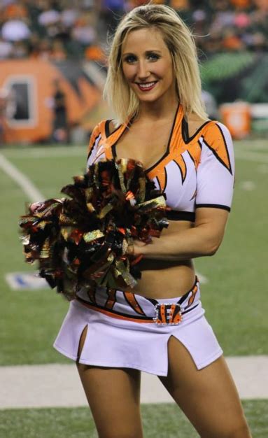 A Cheerleader Is Posing For The Camera