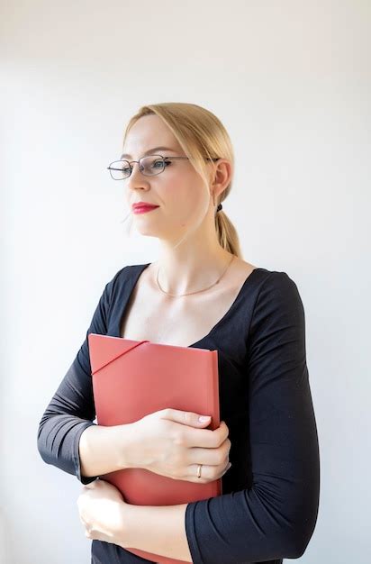 Premium Photo | A young female accountant in a black blouse is standing ...