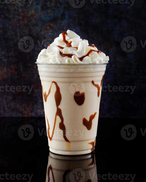 Vanilla Milkshake With Chocolate Syrup In Clear Glass On Dark