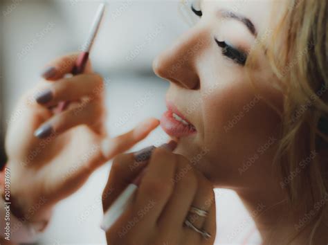 Professional Master Is Applying A Makeup On The Beautiful Girls Face Nude Colored Lip Pencil