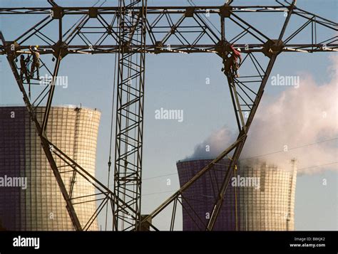 Workers Constructing High Tension Power Line Towers At Electric Power