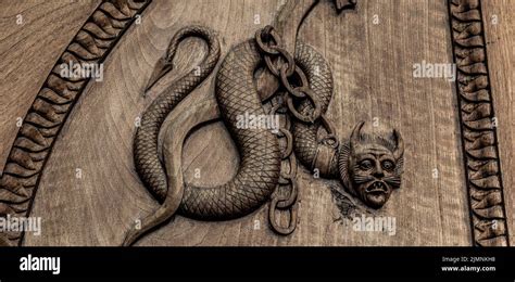 Devil snake symbol. Fantasy magic creature on an old door, 12th Century ...
