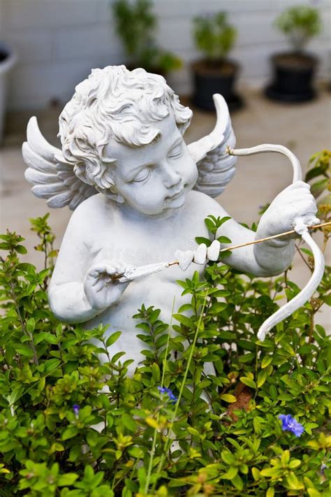 Statue of Cupid in garden stock image. Image of stone - 22097147