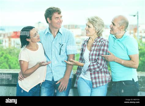 Portrait Of Mature Pleasant Smiling Cheerful Males And Females Talking
