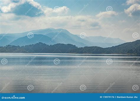 Lake Serene Blue Water With Misty Mountains And Clouds Reflections