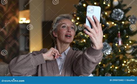 Portrait Of Cheerful Middle Aged Woman Holding Smartphone Make Video