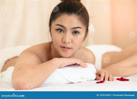 Beautiful Young Woman Lying Down On The Bed Relax In Spa Salon With