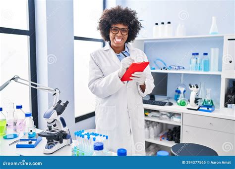 African American Woman Scientist Smiling Confident Using Touchpad At