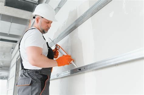 Premium Photo The Builder Fills The Seam Between Plasterboard Plates