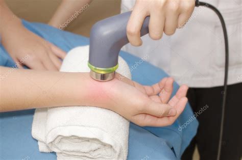 Physical Therapist Using Ultrasound Probe On Woman Patient S Ha