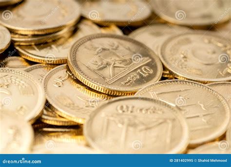 Stacks Of Gold Coins Of Pakistani Currency Symbolize Wealth And