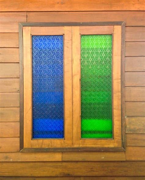 Colorful Blue And Green Glass Windows On Brown Wood Wall