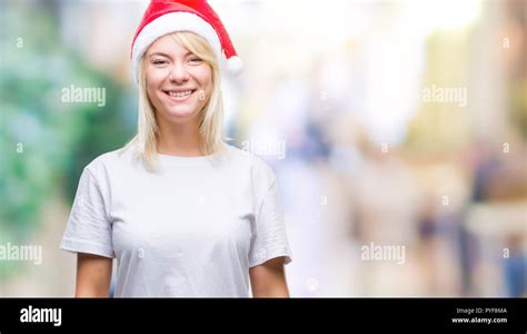 Young Beautiful Blonde Woman Wearing Christmas Hat Over Isolated