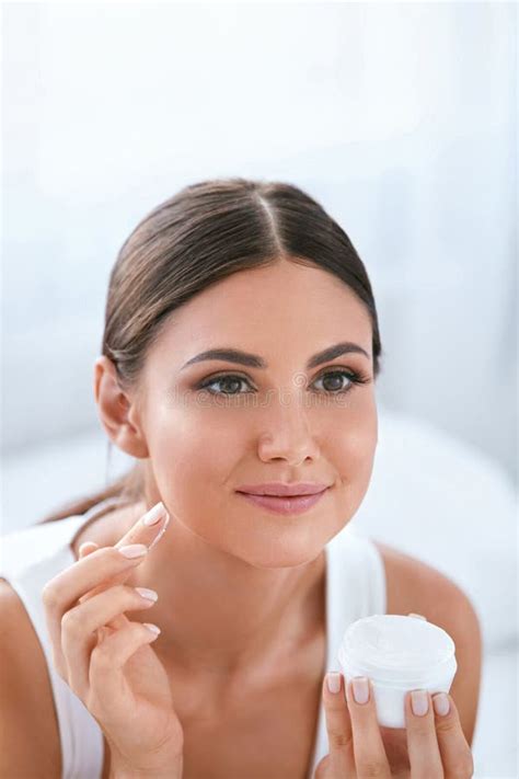 Beauty Beautiful Woman Applying Face Cream On Soft Facial Skin Stock