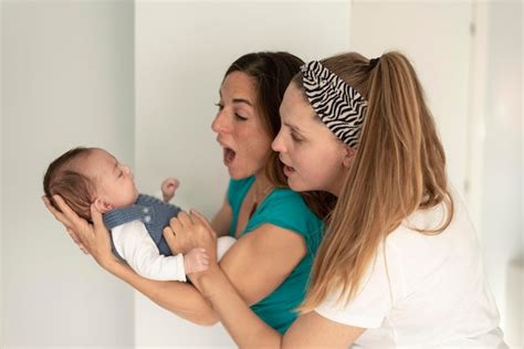 Premium Photo A Lesbian Couple Smiling At Their Baby Gay Marriage Gay