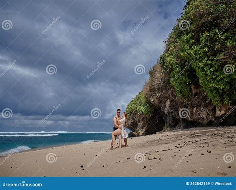 Couple With Swimsuits Posing By The Sea In The Beach In Bali Indonesia