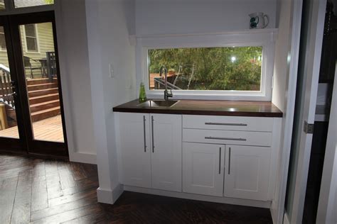 Ikea Sektion cabinets with Grimslov doors, Lansa handles, and walnut