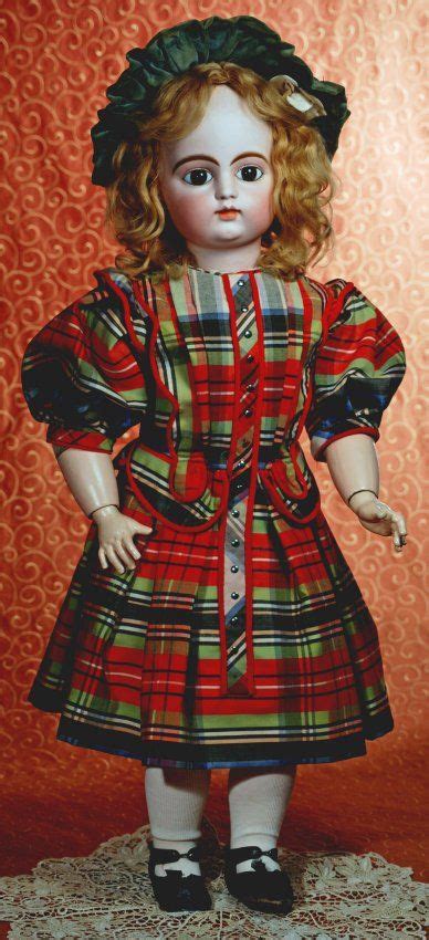 An Old Doll With Blonde Hair Wearing A Red Plaid Dress And Black Shoes