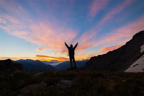 Premium Photo Man Silhouette Standing On Mountain Top Outstretching