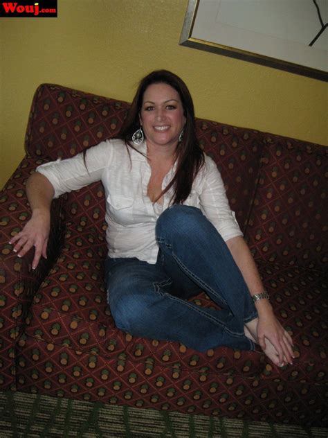 Gorgeous Brunette Chick Posing Fully Clothed On The Couch Photos