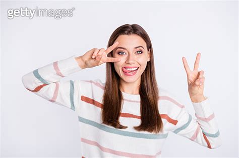 Pretty Lady Showing V Sign Symbol Near Eye Sticking Tongue Out Mouth