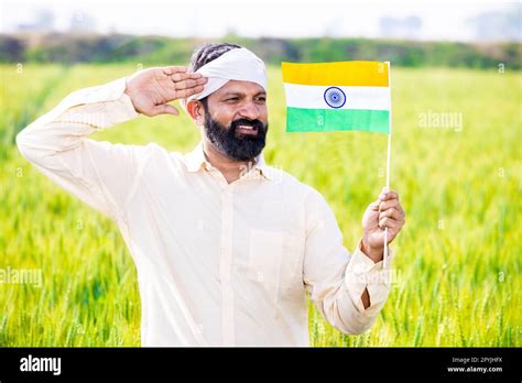 Traditional Rural Farmer Man Holding Indian And Flag Salute While