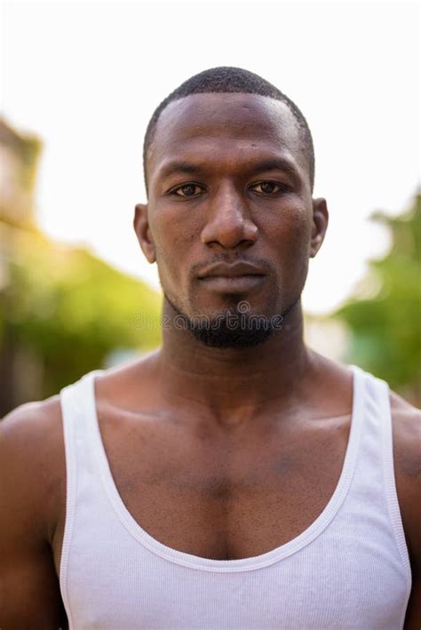 Handsome Muscular African Man Shirtless Against Brown Background Stock