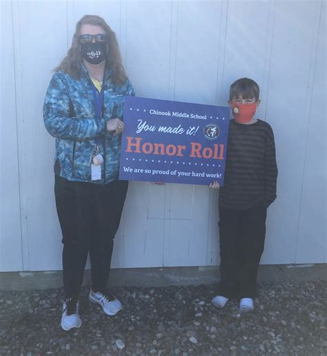 Chinook Middle School - Mrs. Oord delivering an Honor Roll sign to one of her students. We are