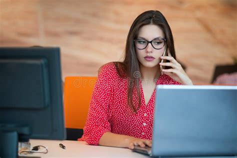 Concentrated At Work Young Beautiful Woman Using Her Laptop While