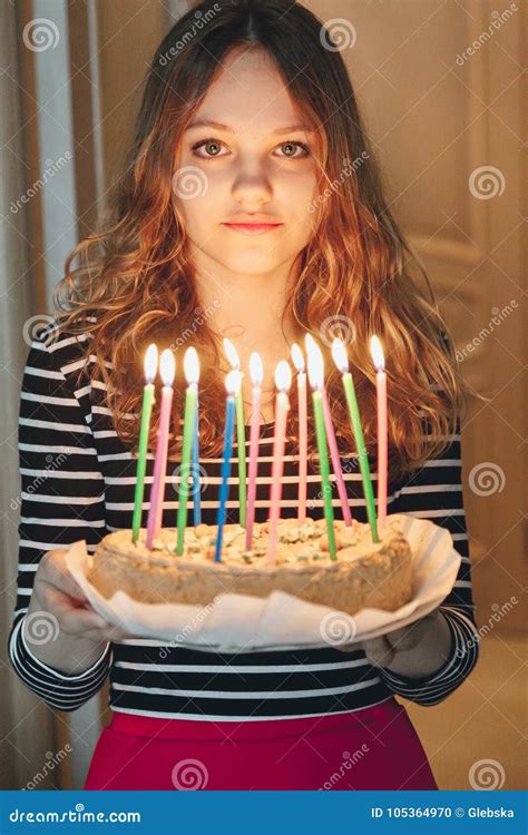 Young Beautiful Girl Holding Cake With Burning Candles Stock Photo