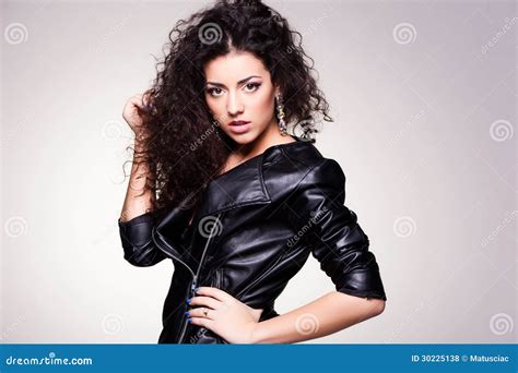 Cute Girl With Curly Hair Wearing A Leather Jacket Studio Shot Stock