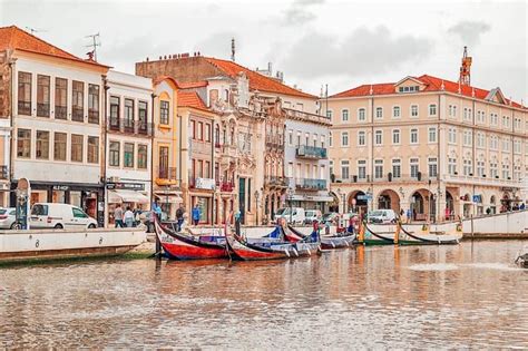 Several Boats Are Docked In The Water Near Buildings