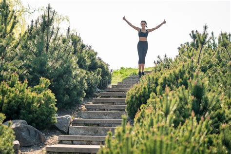 Slender Beautiful Girl With Dark Hair Stands At The Top Of The Steps