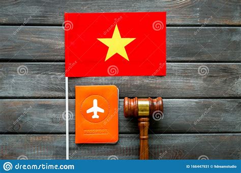 Visa To Vietnam Concept Vietnamese Flag Near Passport And Judge Hammer On Dark Wooden