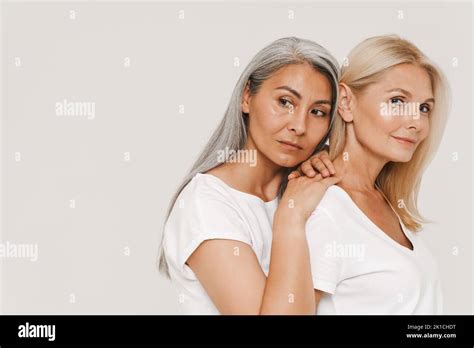 Mature Multiracial Women With Gray Hair Wearing T Shirts Posing At Camera Isolated Over White