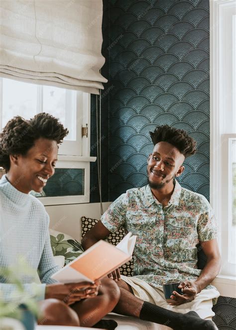 Premium Photo Happy Black Couple Reading A Book At Home