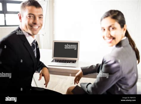 Business people working on laptop Stock Photo - Alamy