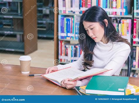 Young Beautiful Asian Female Student Portrait Sitting And Concentrate