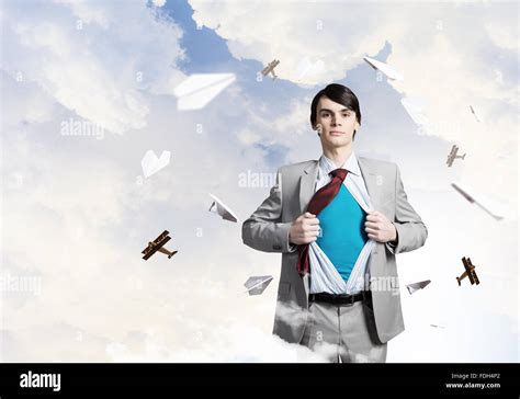 Young Businessman Acting Like Super Hero And Tearing His Shirt Off