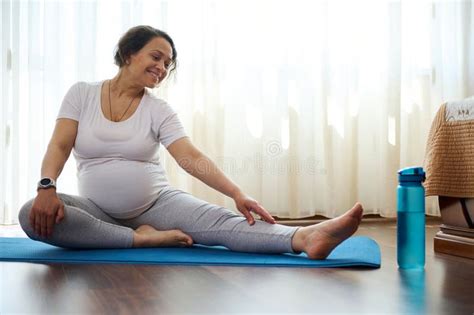 Smiling Happy Pregnant Woman Doing Prenatal Stretching Exercises On