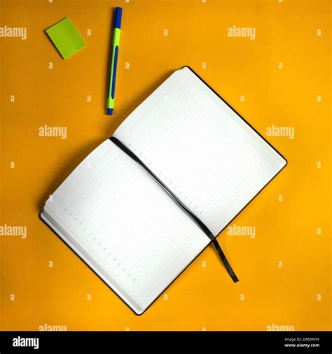 Open Notebook With Pen And Stickers On Orange Background Notebook For