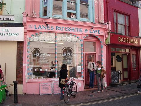 People Are Standing In Front Of A Pink Store