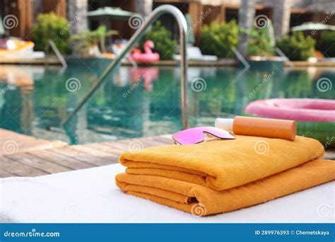 Beach Towels Sunglasses And Sunscreen On Sun Lounger Near Outdoor