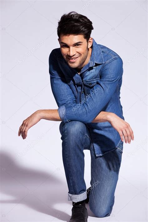 Man Poses On One Knee In Studio Stock Photo By Feedough 12746770