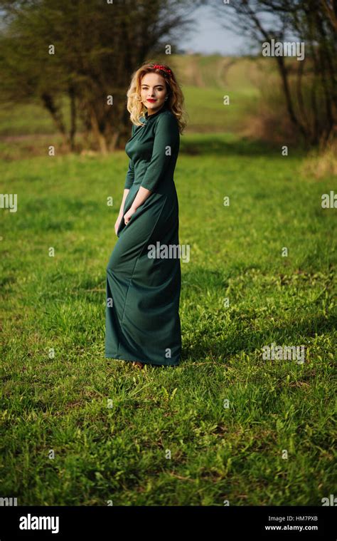 Yong Elegance Blonde Girl At Green Dress On The Garden In Spring Stock