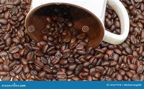 Coffee Beans Spill From A White Ceramic Cup Stock Photo Image Of