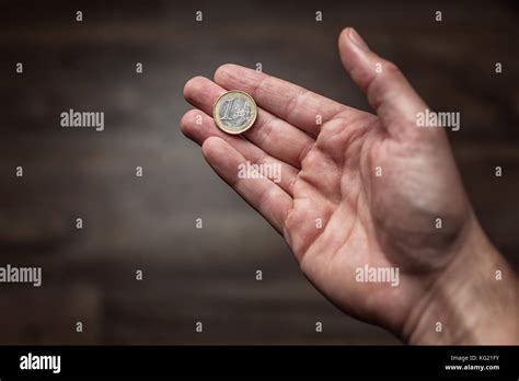 Euro Coin Held In The Palm Of The Hand Stock Photo Alamy