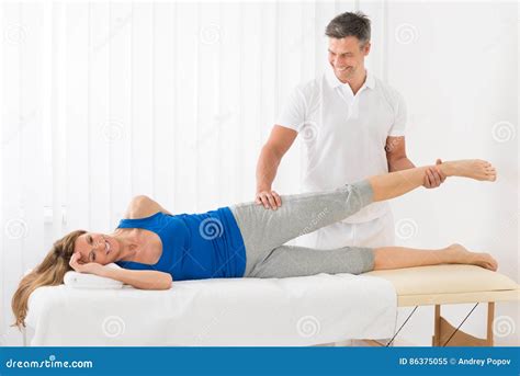 Male Therapist Giving Leg Massage To Woman Stock Image Image Of