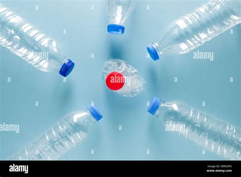 Crushed Plastic Water Bottles With Blue Caps Standing Around Crushed